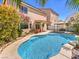 A beautiful backyard featuring a sparkling pool, patio, and lush landscaping, perfect for outdoor living at 6779 Goose Watch Ct, Las Vegas, NV 89139