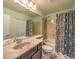 Bathroom featuring marble countertop, decorative shower curtain, and shower-tub combination at 6779 Goose Watch Ct, Las Vegas, NV 89139