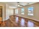 Bright bedroom with hardwood floors, ceiling fan, and three windows offering abundant natural light at 6779 Goose Watch Ct, Las Vegas, NV 89139