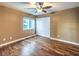 Cozy bedroom featuring hardwood flooring, a ceiling fan, and a double-door closet at 6779 Goose Watch Ct, Las Vegas, NV 89139