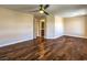 Spacious bedroom with rich hardwood floors and a view of the ensuite bathroom at 6779 Goose Watch Ct, Las Vegas, NV 89139