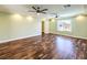 Bright bedroom features wood floors and a ceiling fan, providing ample space and comfort for relaxation and personalization at 6779 Goose Watch Ct, Las Vegas, NV 89139