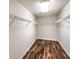 Walk-in closet with hardwood floors and white wire shelving at 6779 Goose Watch Ct, Las Vegas, NV 89139