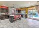 Modern kitchen with an island, stainless steel appliances, and a view of the backyard pool at 6779 Goose Watch Ct, Las Vegas, NV 89139