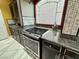A chef-style kitchen boasts modern stainless steel appliances and granite counters at 6779 Goose Watch Ct, Las Vegas, NV 89139