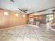 Spacious living room featuring tile floors, a ceiling fan, and an open layout perfect for entertaining and relaxation at 6779 Goose Watch Ct, Las Vegas, NV 89139