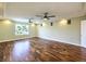 Bright living room with two ceiling fans, hardwood floors, and a view to the outside at 6779 Goose Watch Ct, Las Vegas, NV 89139