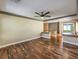 Cozy living room with wood floors and ceiling fan for comfortable living, with view to other rooms at 6779 Goose Watch Ct, Las Vegas, NV 89139