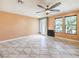 Bright living room offering tile flooring and a ceiling fan, creating a comfortable and aesthetically pleasing space at 6779 Goose Watch Ct, Las Vegas, NV 89139