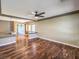 Bright living room featuring hardwood floors, ceiling fan, and sun-filled windows at 6779 Goose Watch Ct, Las Vegas, NV 89139