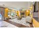Bright living room with modern furnishings, large windows, and a ceiling fan at 6779 Goose Watch Ct, Las Vegas, NV 89139