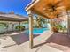 Inviting covered patio with ceiling fans overlooking a sparkling pool and beautifully landscaped backyard at 6779 Goose Watch Ct, Las Vegas, NV 89139