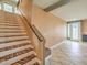 Elegant staircase with decorative carpet leading to the upper level and a view of the front door at 6779 Goose Watch Ct, Las Vegas, NV 89139