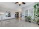 Inviting living room featuring tile flooring, plenty of plants, and an open floor plan leading into other rooms at 6971 Moaning Cavern St, Las Vegas, NV 89131