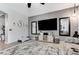 Bright living room showcasing neutral decor, decorative mirrors, and a modern entertainment center at 6971 Moaning Cavern St, Las Vegas, NV 89131