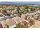 Scenic aerial view showcases tile roofs, desert landscape and neighborhood streets at 7641 Sea Wind Dr, Las Vegas, NV 89128