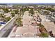 Community shot features well-kept houses and mature desert landscaping from an aerial view at 7641 Sea Wind Dr, Las Vegas, NV 89128