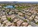 Picturesque aerial view of a community with tree-lined streets and a serene lake at 7641 Sea Wind Dr, Las Vegas, NV 89128