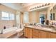 Bathroom featuring double sinks, granite countertops, and a shower-tub combination at 7641 Sea Wind Dr, Las Vegas, NV 89128