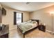 Cozy bedroom with large window, ceiling fan, and neutral decor at 7641 Sea Wind Dr, Las Vegas, NV 89128
