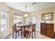 Cozy dining area bathed in natural light, complete with a wooden table and stylish chairs at 7641 Sea Wind Dr, Las Vegas, NV 89128