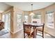 Bright dining area featuring a wooden table, comfortable chairs, and sliding glass door access at 7641 Sea Wind Dr, Las Vegas, NV 89128