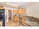 View of kitchen featuring light wooden cabinets, granite countertops, and stainless steel appliances at 7641 Sea Wind Dr, Las Vegas, NV 89128