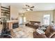 Inviting living room with a brick fireplace and large windows for ample natural light at 7641 Sea Wind Dr, Las Vegas, NV 89128