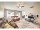 Comfortable living room with a ceiling fan, neutral walls and plenty of natural light at 7641 Sea Wind Dr, Las Vegas, NV 89128