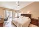 Well-lit main bedroom with a ceiling fan, patio access, and stylish furnishings at 7641 Sea Wind Dr, Las Vegas, NV 89128