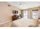 Bright main bedroom featuring a ceiling fan, desk area, backyard access, and neutral décor at 7641 Sea Wind Dr, Las Vegas, NV 89128