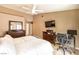 Spacious main bedroom featuring a ceiling fan, TV, desk and tasteful décor at 7641 Sea Wind Dr, Las Vegas, NV 89128