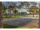 An outdoor volleyball court offers recreational opportunities with a serene lake view surrounded by lush greenery at 7641 Sea Wind Dr, Las Vegas, NV 89128