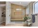 Luxurious bathroom with dual shower heads, glass enclosure, bench, and open shelving at 7805 Leavorite Dr, Las Vegas, NV 89128