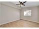 Bright bedroom featuring wood-look flooring, neutral walls, and a modern ceiling fan at 7805 Leavorite Dr, Las Vegas, NV 89128