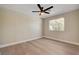 Bright bedroom featuring wood-look flooring, neutral walls, and a modern ceiling fan at 7805 Leavorite Dr, Las Vegas, NV 89128