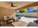 Inviting covered patio with a ceiling fan and an outdoor seating area overlooking the pool at 7805 Leavorite Dr, Las Vegas, NV 89128