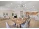Bright, open dining area with stylish light fixture and access to a modern kitchen at 7805 Leavorite Dr, Las Vegas, NV 89128