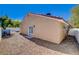 Exterior view of the house and surrounding backyard with desert landscaping at 7805 Leavorite Dr, Las Vegas, NV 89128