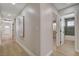 Hallway with modern paint color, art on the wall, and a door to a bathroom at 7805 Leavorite Dr, Las Vegas, NV 89128
