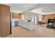 Bright, open kitchen with marble countertops, leading to a cozy living space with a fireplace at 7805 Leavorite Dr, Las Vegas, NV 89128