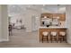 Bright kitchen with an island featuring a breakfast bar, seamlessly flowing into the living spaces at 7805 Leavorite Dr, Las Vegas, NV 89128