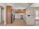 Open kitchen featuring stainless steel appliances, a marble island, and access to outdoor pool area at 7805 Leavorite Dr, Las Vegas, NV 89128