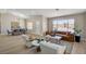 Open concept living area with dining space, comfortable seating, and ample natural light at 7805 Leavorite Dr, Las Vegas, NV 89128