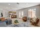 Sunlit living area featuring modern furnishings, decor, and open access to the kitchen at 7805 Leavorite Dr, Las Vegas, NV 89128