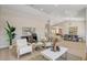 Inviting living room with light wood floors and comfortable seating arrangement at 7805 Leavorite Dr, Las Vegas, NV 89128