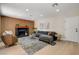 Inviting living room with a fireplace, modern furniture, and an attractive accent wall at 7805 Leavorite Dr, Las Vegas, NV 89128