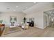 Spacious living room with modern furniture, wood floors, and contemporary artwork at 7805 Leavorite Dr, Las Vegas, NV 89128