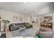 Bright, open-concept living room with modern decor flowing into dining and kitchen areas at 7805 Leavorite Dr, Las Vegas, NV 89128