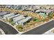 Aerial view of modern home with lush landscaping, backyard putting green, desert foliage, and neighboring luxury houses at 787 Keyland St, Las Vegas, NV 89138